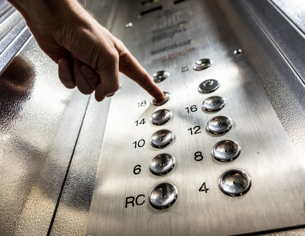 Person pushing elevator buttons