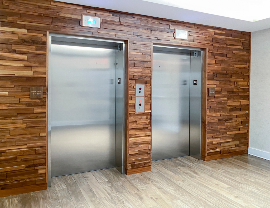 Wooden wall paneling outside elevator bank