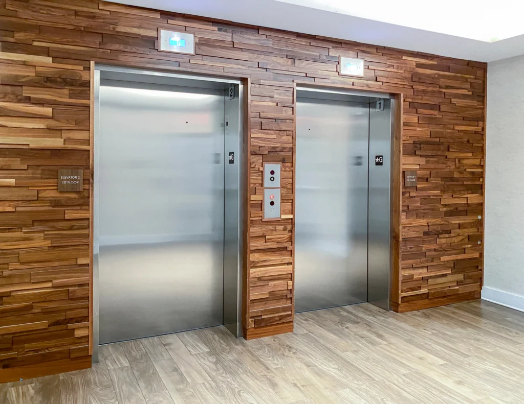 Wooden wall paneling outside elevator bank